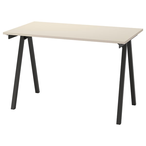 A trottan desk in beige. It has a rectangular top, black metal legs, and a simplistic design.