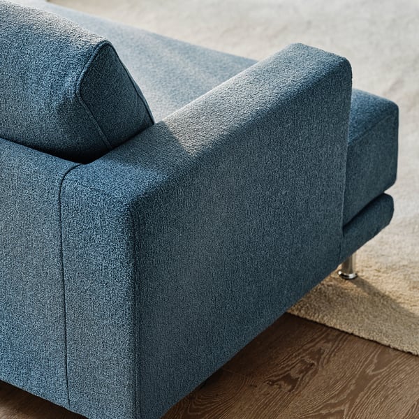 Close-up of a well-crafted, modern blue sofa, showing plush cushions and sturdy build.