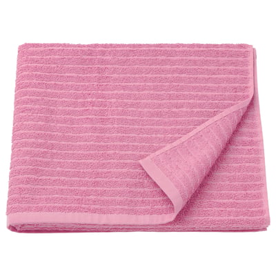 A folded bright pink VÅGSJÖN towel made of 100% cotton, featuring a textured design.