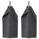 Two dark grey VÅGSJÖN towels hang side by side on hooks, featuring striped texture and folded tops.