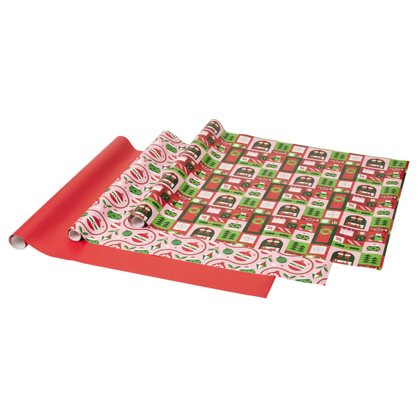 Roll of red gift wrapping paper with christmas themes. Colourful squares, text, and symbols.