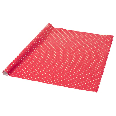 Red gift wrap with white snowflake pattern, rolled and flattened, festive holiday design.