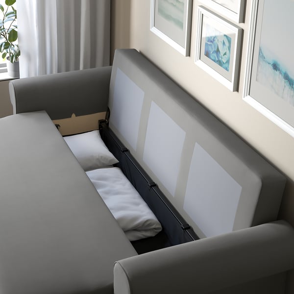 Sofa-bed with easy convertible back, storage, and cosy cushions.