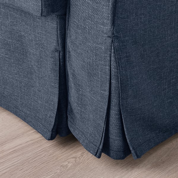 Dark blue fabric sofa-bed close-up, showing textured cover detail.