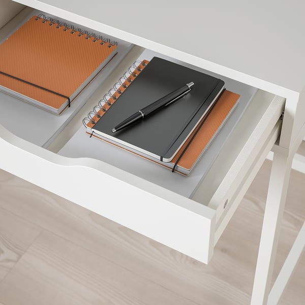 An ALEX desk with inner drawers for notebooks and a pen, with built-in cable management, and a sleek minimalist design.