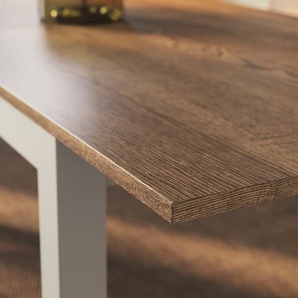 Close-up of ÅLHULT table with smooth, ash veneer surface and clear lacquer finish.