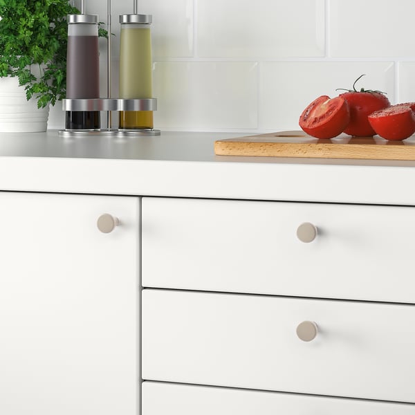 White kitchen handles on drawers. Modern, smooth, epoxy-coated steel knobs for white cabinets.