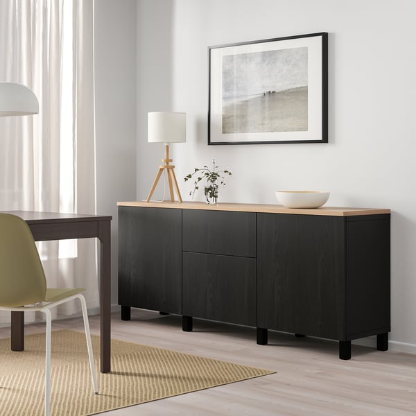Modern room with BESTÅ sideboard & coastal photo.