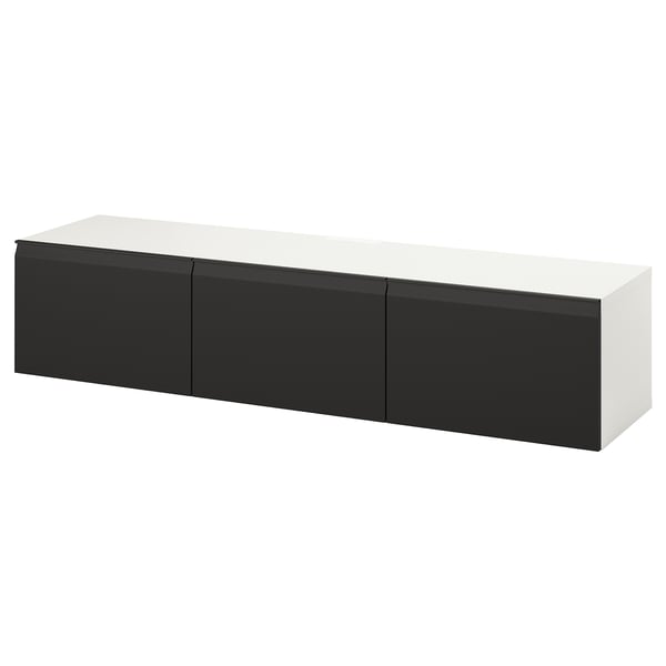 A white and black BESTÅ tv bench. It has a sleek, rectangular shape with three compartments, offering modern design and ample storage.