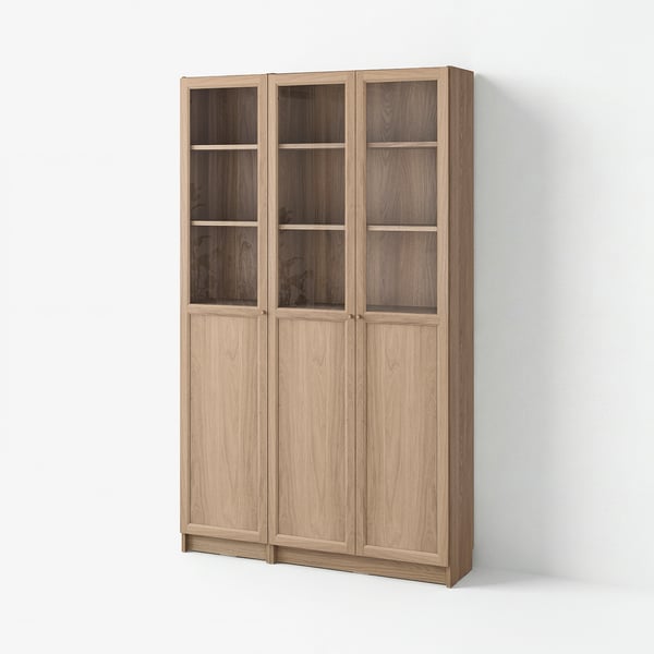 BILLY wood bookshelf. Tall, light brown, rectangular, with glass top doors and wooden lower doors.
