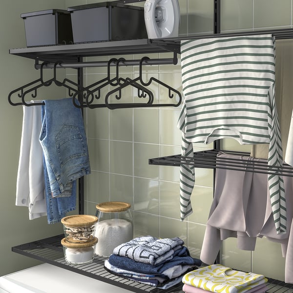 Laundry organiser: clothes hangers, shelves with detergent, clean clothes drying.