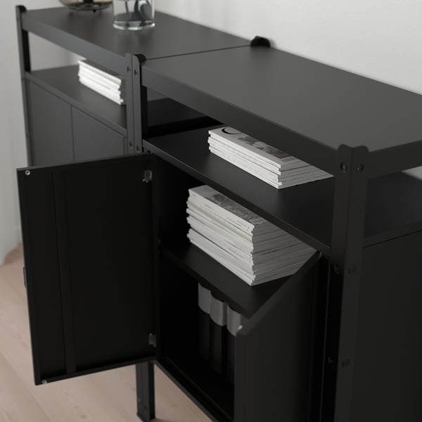Black metal storage unit with multiple shelves holding stacks of papers, designed for heavy loads and easy expansion.