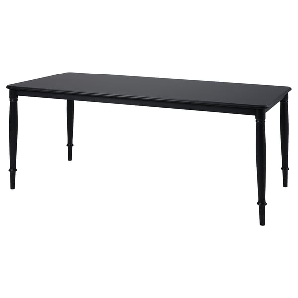 Black rectangular dining table with four tapered legs, made of steel and lacquered mdf.