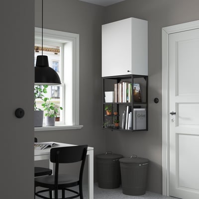 Modern home office with ENHET cabinet, desk, plants, and black accents.