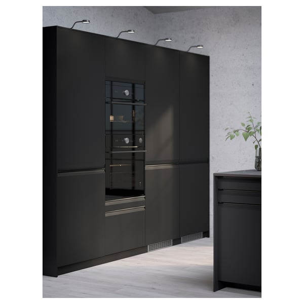 Modern kitchen featuring black integrated appliances and sleek cabinetry.