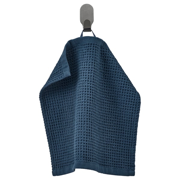 Blue GULLDYNA towel hangs on hook, textured, dark blue, cotton, rectangular.