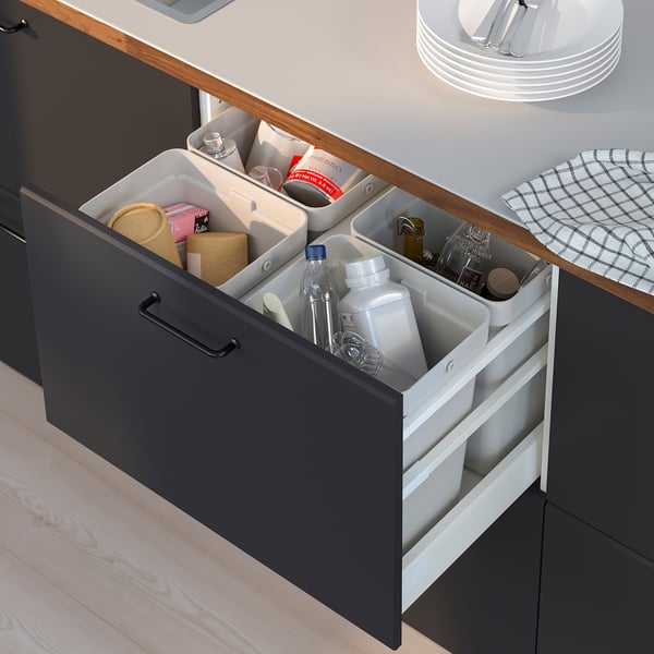 Open kitchen drawer with HÅLLBAR sorting bins for recyclables and waste.