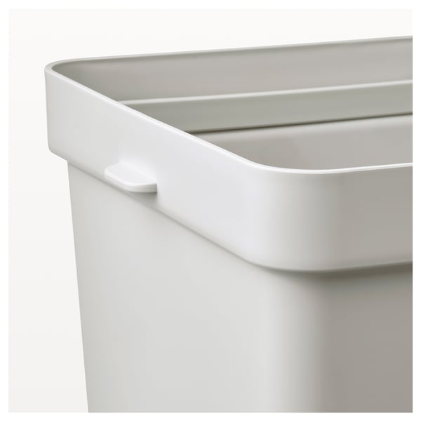 Close-up of white hallbar bin, showing sleek design with handle, clean interior, and removable ring.