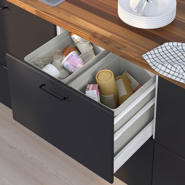 Drawer with sorted waste bins: plastic, paper, cardboard, hidden handles.