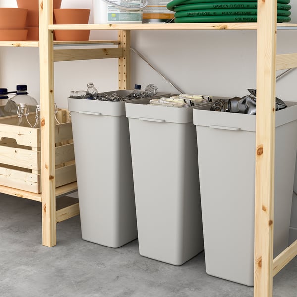 Three HÅLLBAR bins on shelves, each filled with different recyclables.