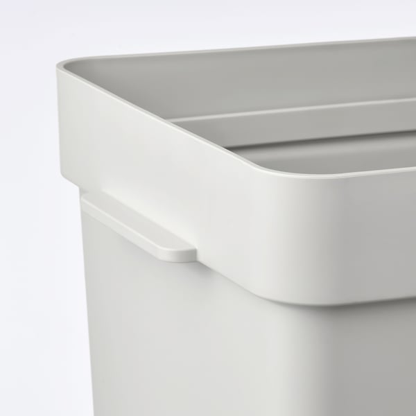 Close-up of white HÅLLBAR recycling bin handle, sleek design, clean edges, sturdy material.