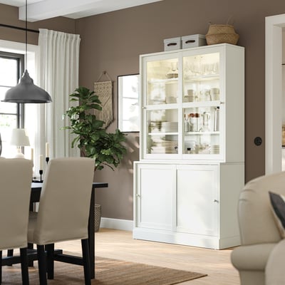 White HAVSTA sideboard with glass doors, solid pine, rustic, modern, with chairs, plant, curtains, rug.