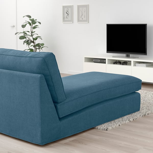 Blue KIVIK chaise longue. Modern, minimalist design. Large size, fits well in spacious living rooms. Accompanied by tv and decor.