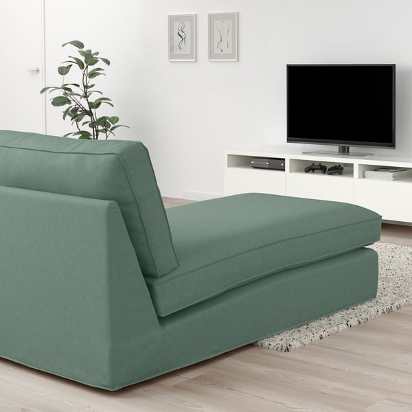 Modern green KIVIK chaise longue beneath tv, soft & durable, fits cosy living room.