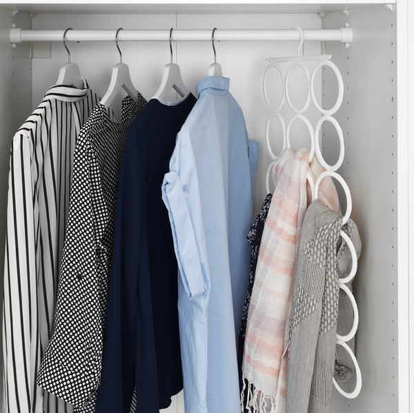 Organised closet with shirts and scarves. KOMPLEMENT hanger displays shawls neatly on right.