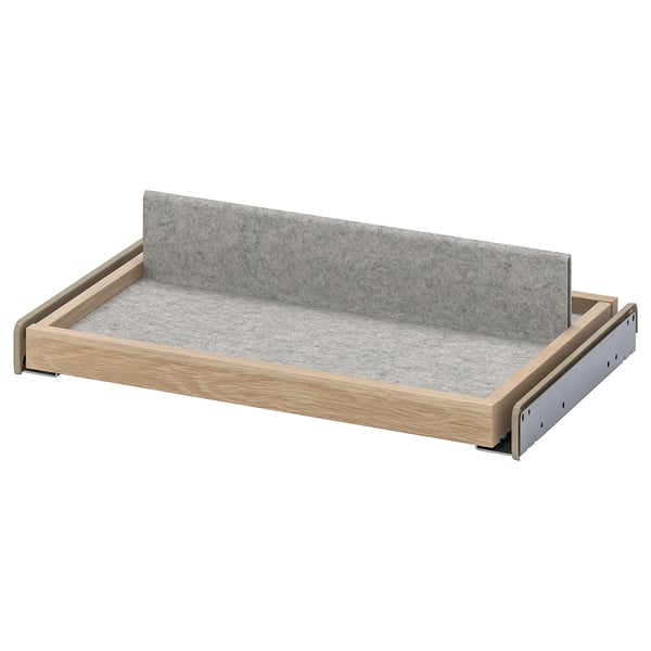 IKEA KOMPLEMENT pull-out tray in light beige wood with grey felt liner, rectangular shape. Modern design, ideal for organising accessories.