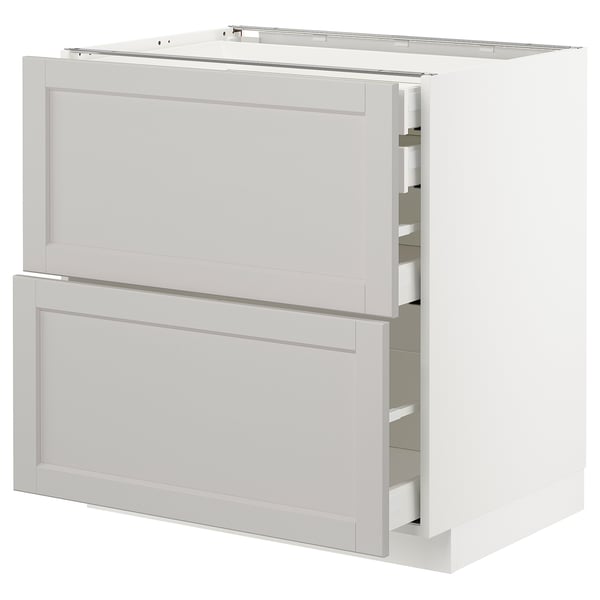 A white METOD kitchen cabinet with two shallow drawers and one larger drawer, featuring classic grey panels and bevelled edges.