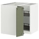 A white METOD kitchen cabinet with a green door open, revealing adjustable shelves.