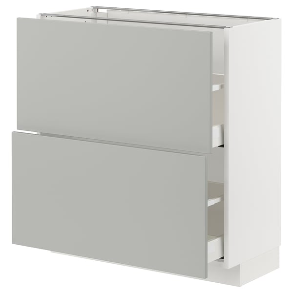 A white METOD kitchen cabinet with light grey drawers. The cabinet is rectangular and multiple compartments.
