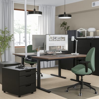 Home office with MITTZON desk, green chair, dual monitors, black storage, cable management, minimalist design.