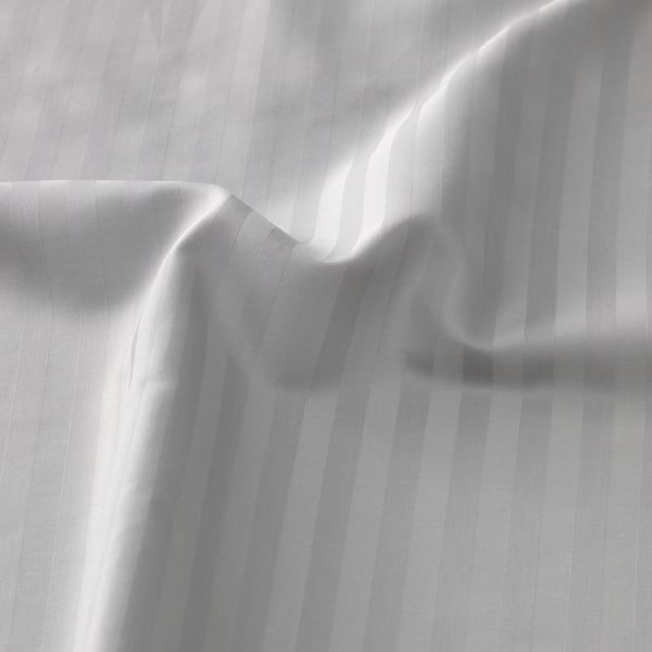 Smooth, striped bed sheet close-up showing luxurious texture.