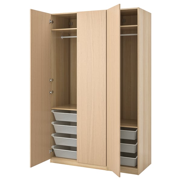 Wooden PAX wardrobe with open doors, light oak finish, grey mesh baskets, and adjustable shelves.