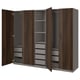 An open ikea PAX wardrobe in dark brown with shelves and drawers. It has a wooden finish and modern design.