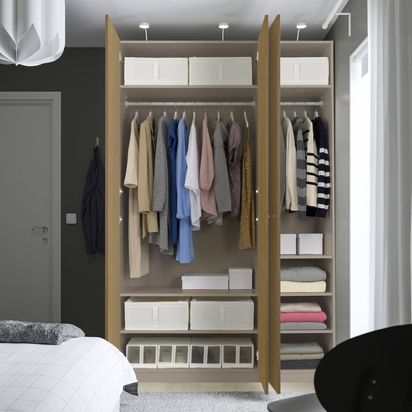 Modern open wardrobe with clothes and storage boxes, adjustable shelves and lighting.
