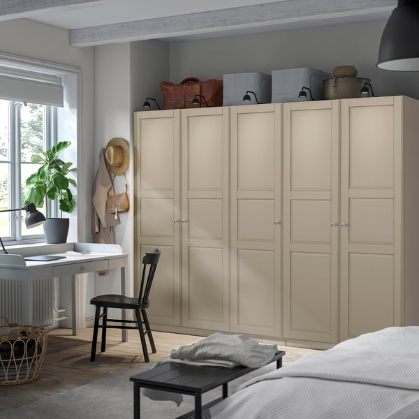 Beige PAX wardrobe with desk, chair, & bed.