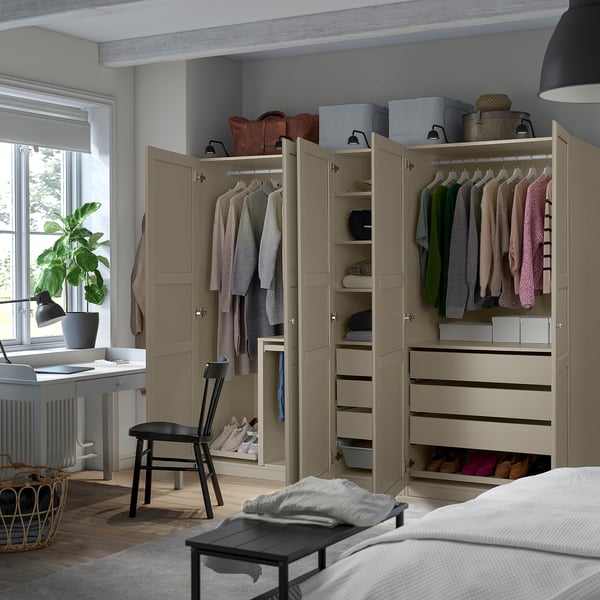 Bedroom with wardrobe, clothes, and storage. Wardrobe has hanging, shelves, and drawers.
