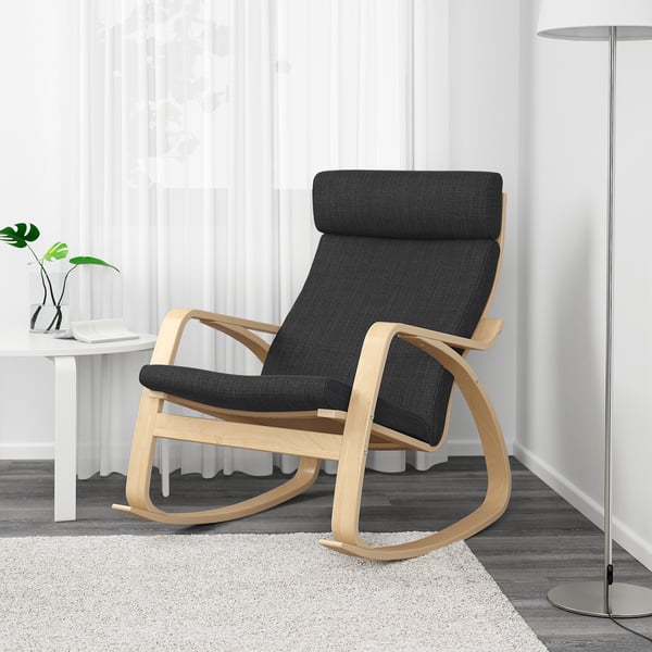 Modern rocker chair with dark grey cushion and light wood frame in living room.