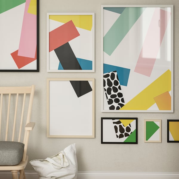 Colourful prints with pastel shapes, a chair, and a pillow.