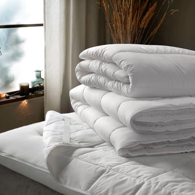 White SÄFFEROT duvet, large, neatly stacked on bed, soft, recycled material.