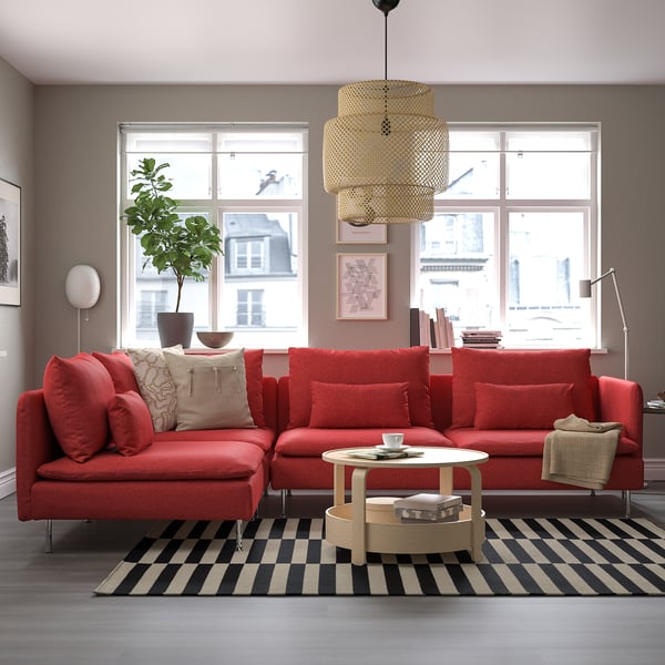 Modern red l-shaped SÖDERHAMN sofa, striped rug, black & white. Soft fabric, big windows, plush cushions.