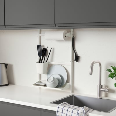 Modern kitchen with wall-mounted SUNNERSTA organiser: small, white, steel, holding dishes, utensils, and paper towels.