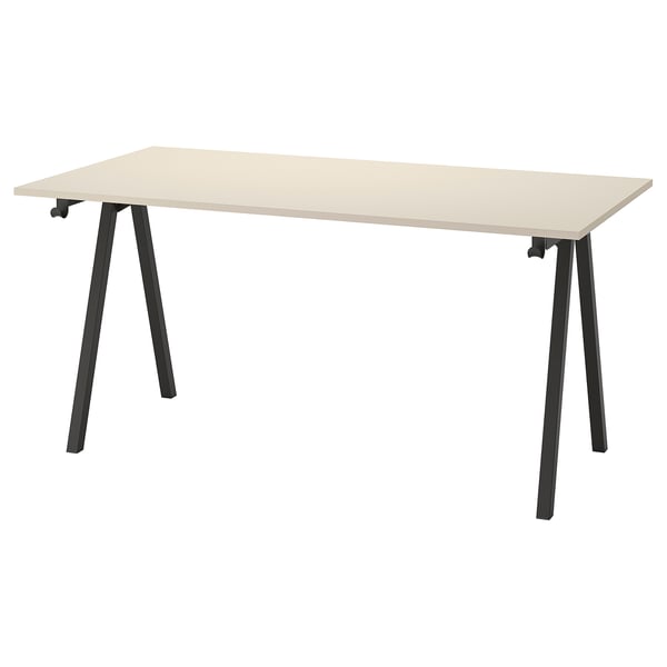 A TROTTEN desk in beige. Its rectangular with a-shaped black metal legs. The design is sturdy and functional for office work.