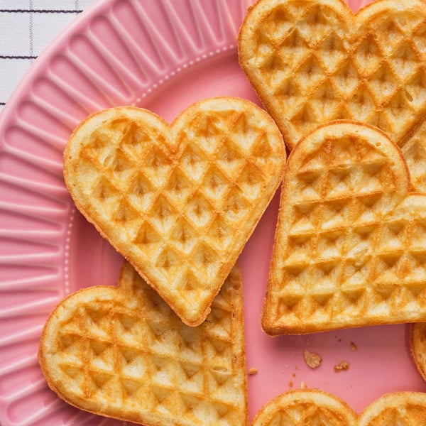 Heart-shaped waffles, crispy outside, soft inside. Served with jam, cream, or salmon. Perfect for dessert or appetisers.