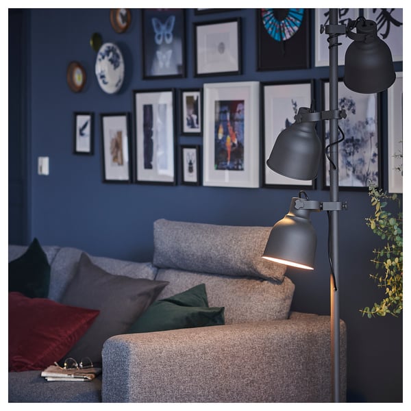 Cosy living room with VIMLE sofa in grey, colourful pillows, modern floor lamp, and blue wall with picture frames.
