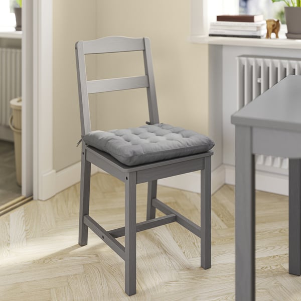 A VIPPÄRT chair pad in grey, thickly cushioned with ties for secure fit on hauga, pinntorp, and stefan chairs.