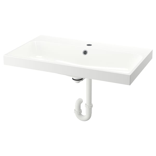 A white BACKSJÖN wash-basin. Its rectangular, sleek, and made of crushed marble. The design is modern and minimalist.